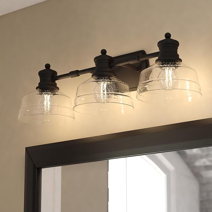 VAXCEL Beloit 3-Light 25.5 in. Wide Matte Black Farmhouse Bathroom Vanity Lighting Fixture, Clear Seeded Glass Shade, Dimmable, LED Compatible, Reversible Over The Mirror Mounted Steel Wall Sconce