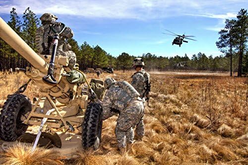 Paratroopers prepare to hook up an M119A2 howitzer to a UH-60M Black Hawk Poster Print by Stocktrek Images (17 x 11)